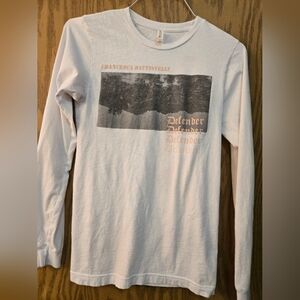 Very cute long sleeve "Defender" concert tee. Size small.